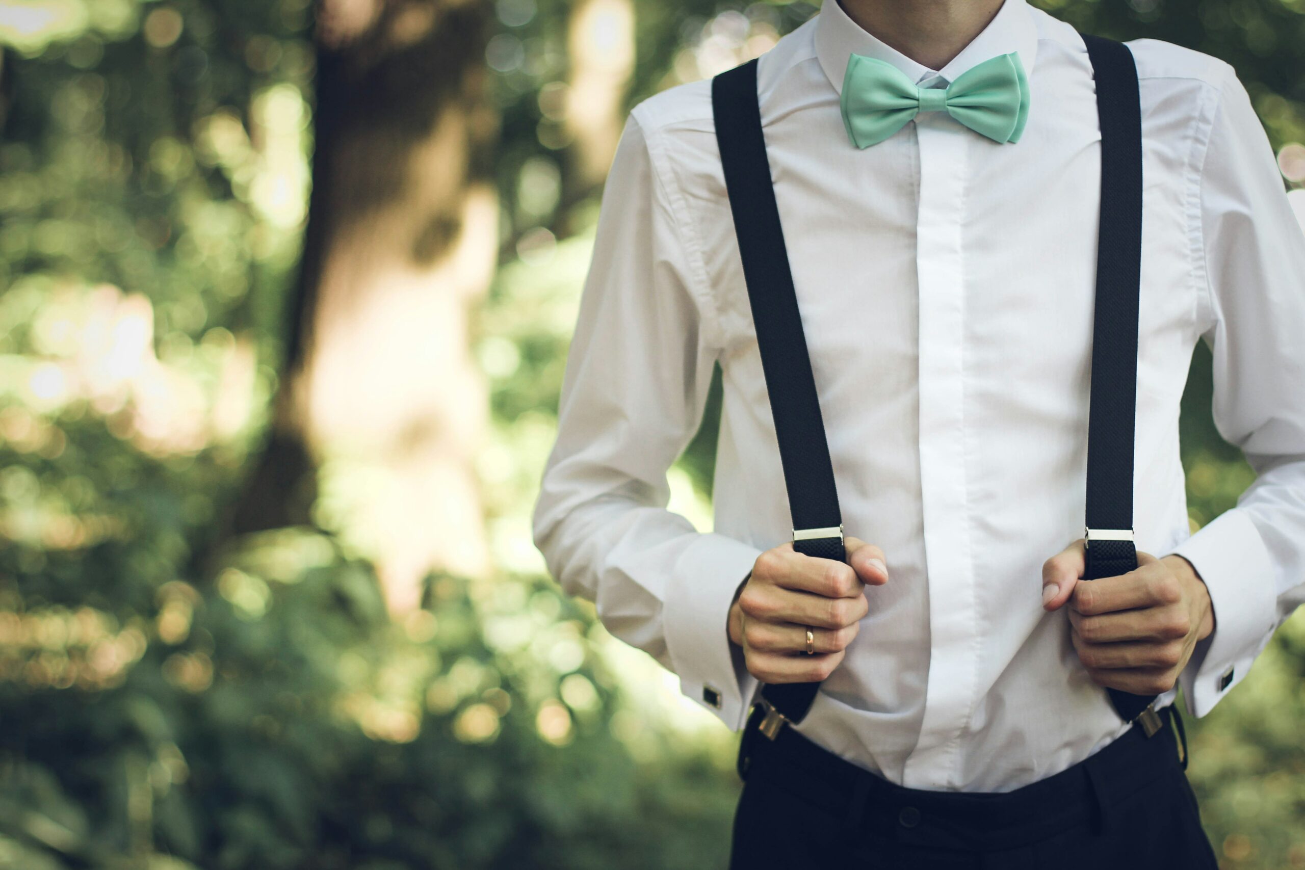 A person in green bow tie and suspenders is seen from neck to navel. The Benefits of Hiring Professional Budtenders for Your Weed Bar Service image.